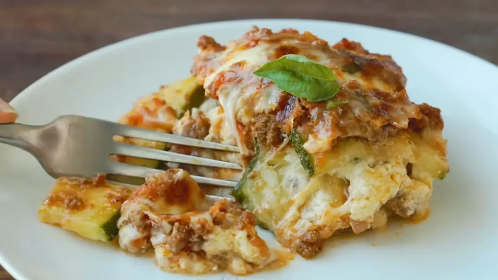 Easy Zucchini Lasagna Recipe 3 Slice of zucchini lasagna served with basil garnish on a white plate