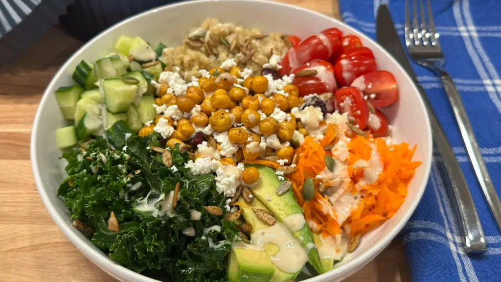 Harvest Quinoa Bowl with Creamy Tahini Dressing 3 Fully assembled quinoa bowl topped with seeds and pomegranate
