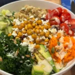 Fully assembled quinoa bowl topped with seeds and pomegranate