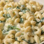 Bowl of creamy ricotta lemon pasta garnished with basil and lemon zest