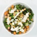 Harvest quinoa bowl with sweet potatoes, chickpeas, and tahini dressing