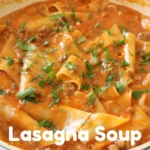Hearty lasagna soup in a bowl topped with ricotta, melted mozzarella, and fresh basil
