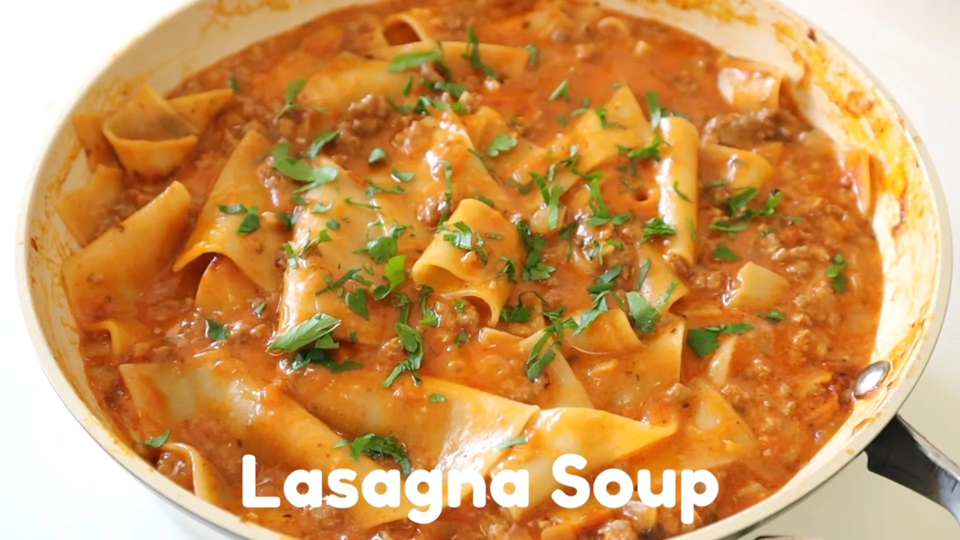 Easy Lasagna Soup Recipe 1 Hearty lasagna soup in a bowl topped with ricotta, melted mozzarella, and fresh basil
