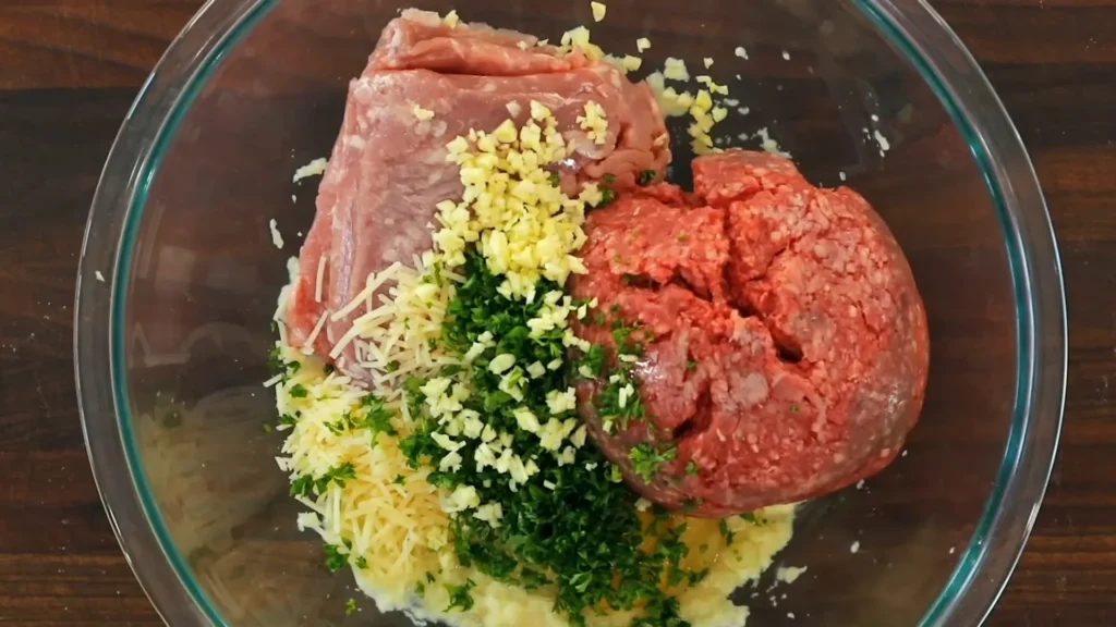 Soft & Juicy Ricotta Meatballs Recipe 2 Mixing ground meat with ricotta and herbs in a large bowl