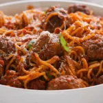 Juicy ricotta meatballs in tomato sauce garnished with basil