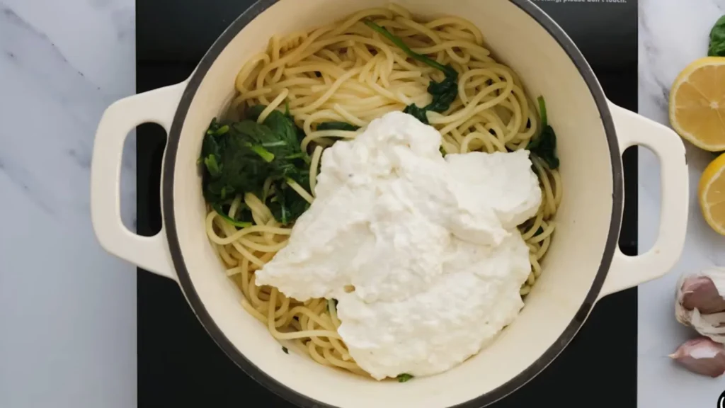 Easy Ricotta Lemon Pasta Recipe 2 Spaghetti being tossed with creamy lemon ricotta sauce in a skillet
