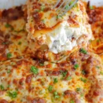 Baked lasagna with melted mozzarella and basil garnish