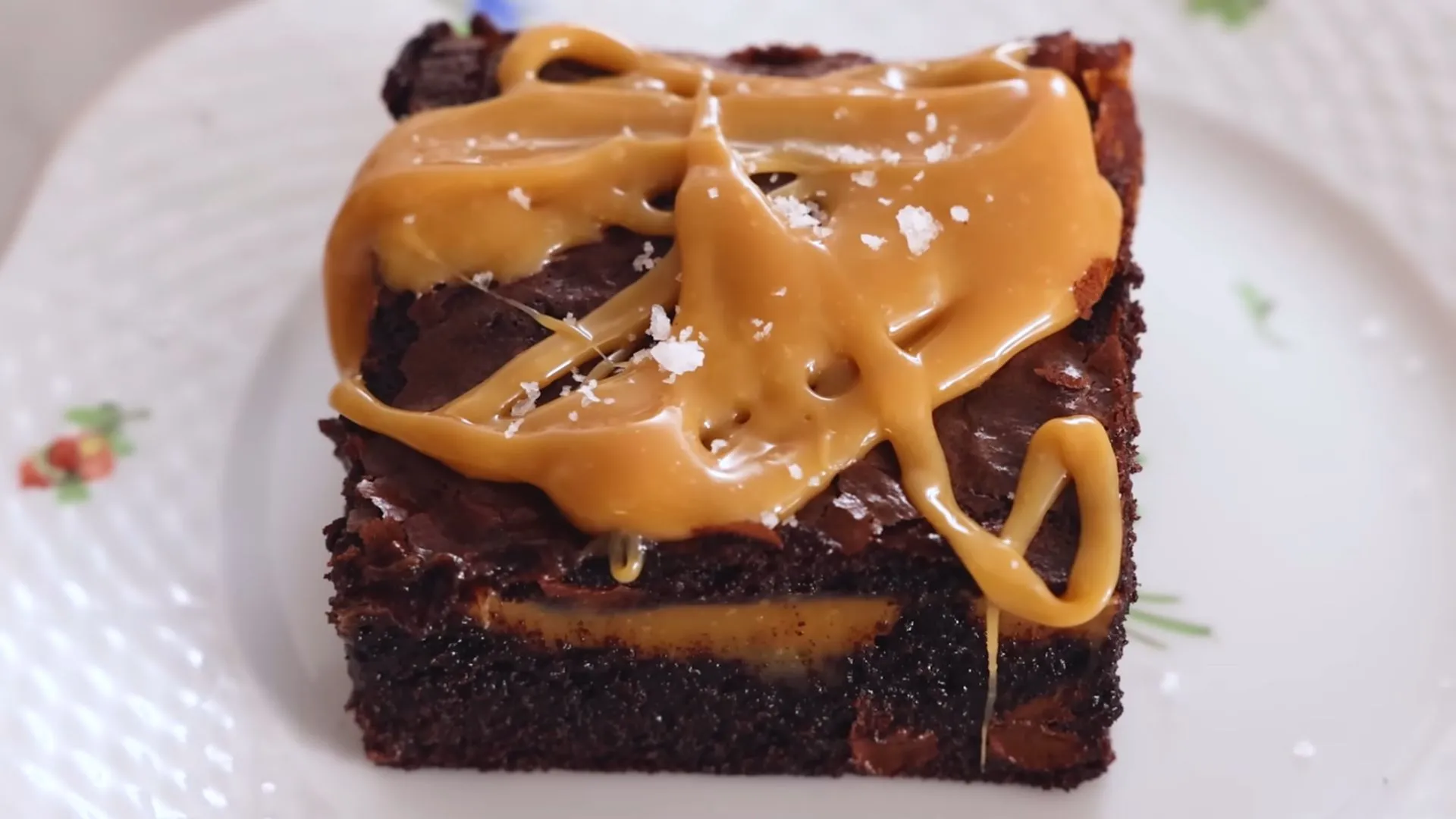 Easy Salted Caramel Brownies Recipe 4 Salted caramel brownie slice with sea salt on white plate