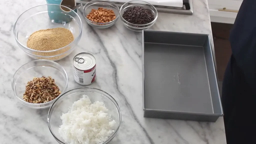 Easy Seven Layer Bars Recipe – No Mixer Needed 2 Ingredients for easy seven layer bars including coconut and chips.