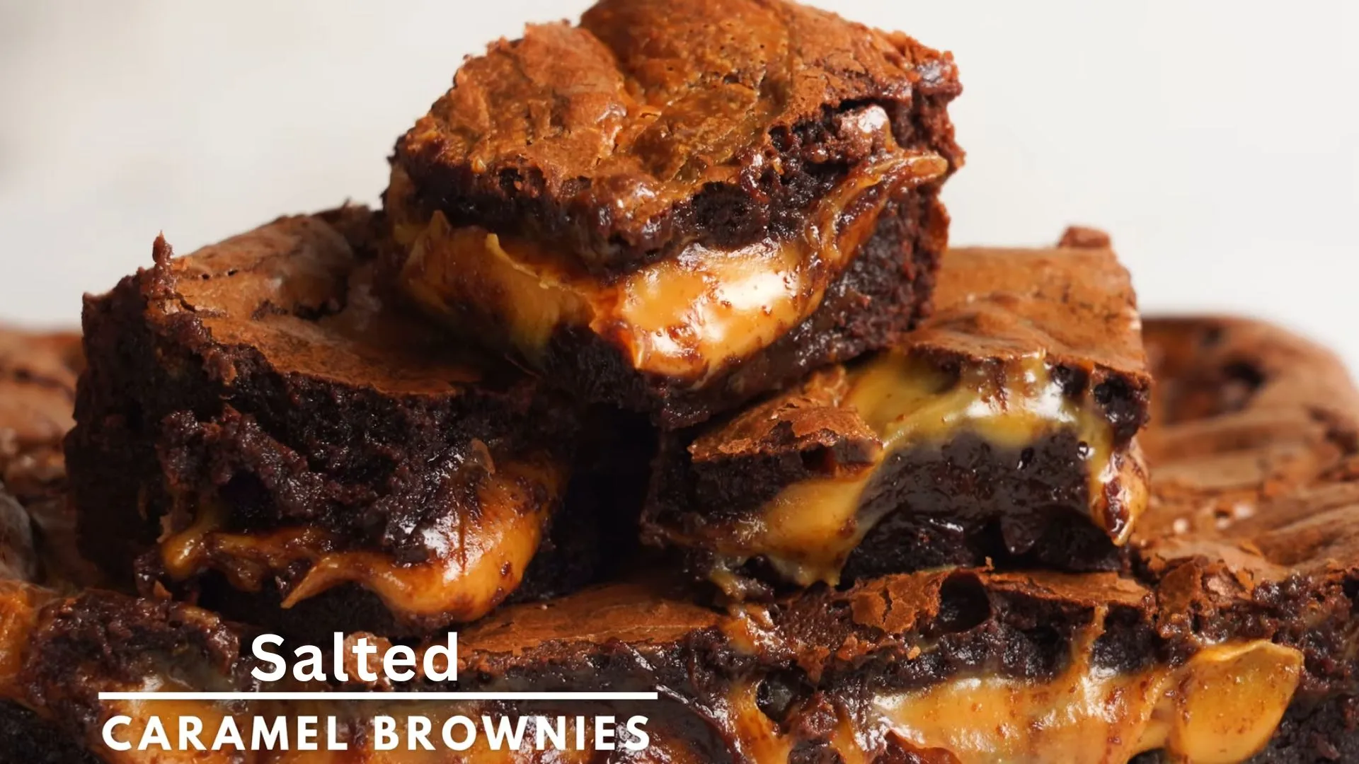Easy Salted Caramel Brownies Recipe 1 Stacked salted caramel brownies with sea salt and caramel drizzle