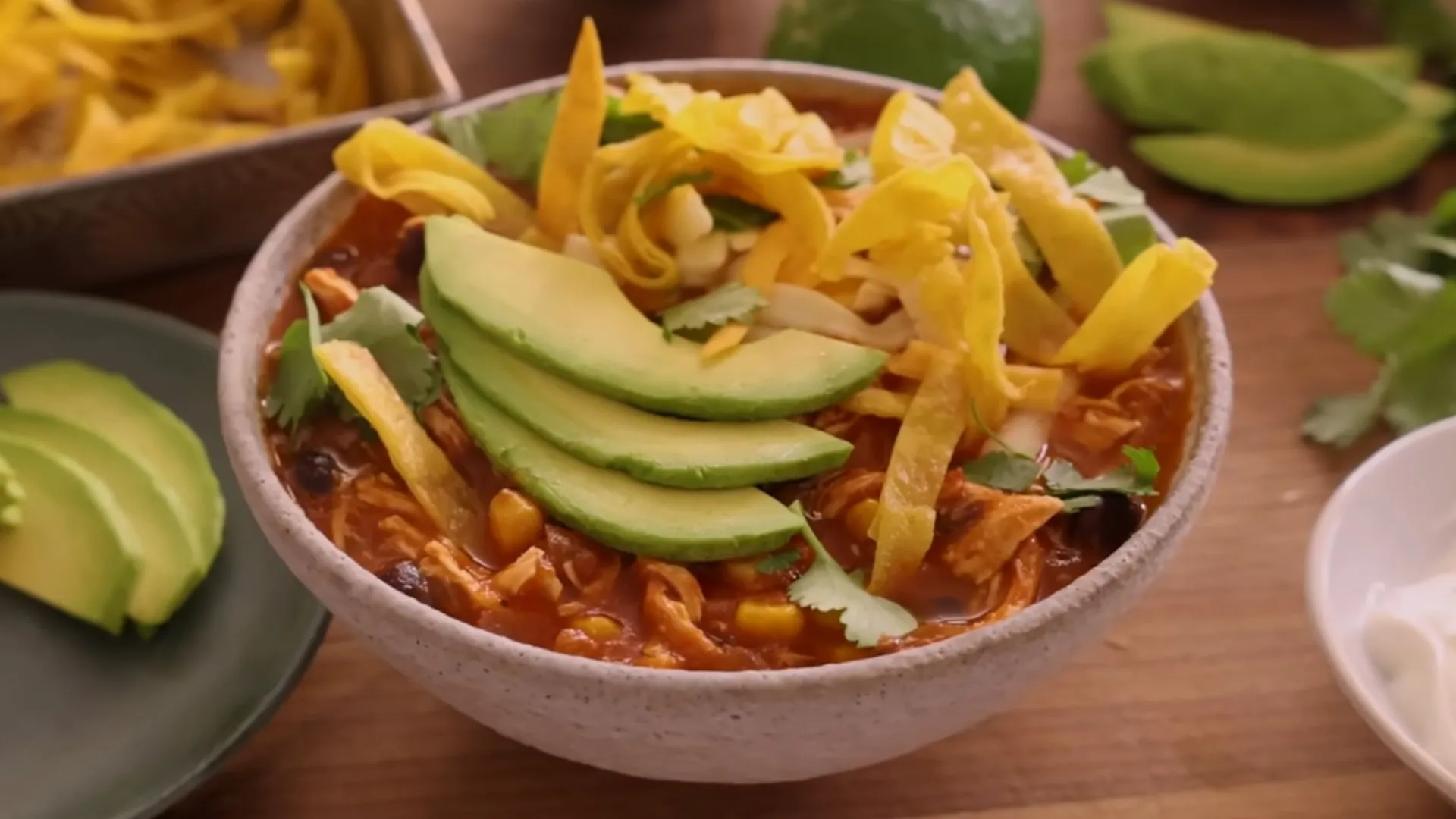 Easy Homemade Chicken Tortilla Soup 1 Bowl of chicken tortilla soup garnished with avocado, tortilla strips, and cilantro
