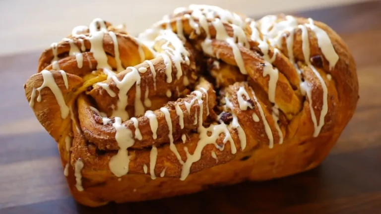 Cinnamon Roll Pumpkin Bread with Cream Cheese Glaze Recipe 9 Freshly baked cinnamon roll pumpkin bread with cream cheese glaze dripping over the sides.