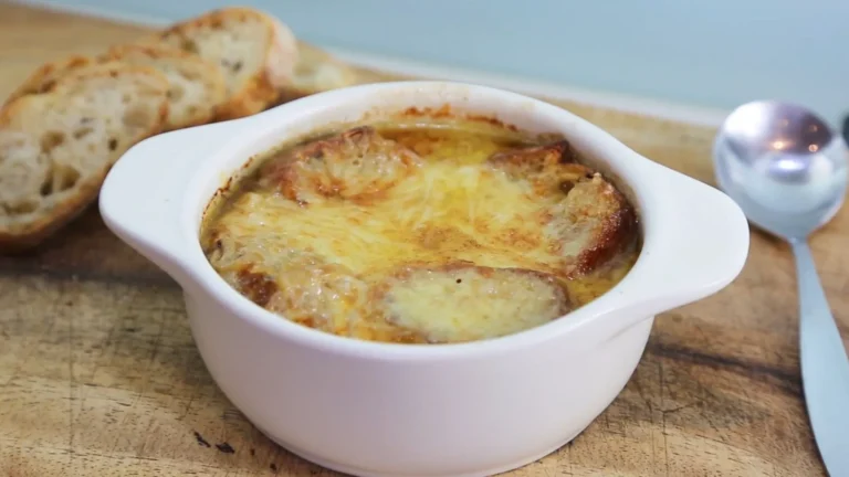 Easy French Onion Soup Recipe: Cheesy & Comforting 5 Golden, cheesy French onion soup in a rustic bowl with toasted bread.