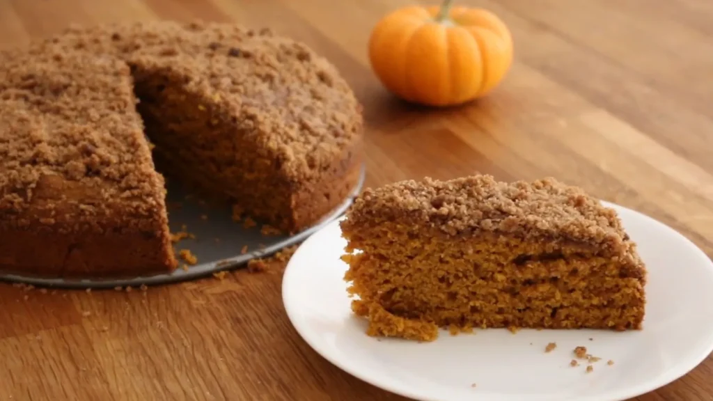 Pumpkin Coffee Cake Recipe (Moist & Cozy for Fall) 3 Slice of pumpkin coffee cake served with mug of coffee