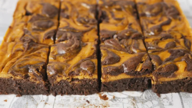 Pumpkin Cheesecake Swirl Brownies Recipe | Fudgy Fall Dessert 9 Freshly baked pumpkin cheesecake swirl brownies cut into squares