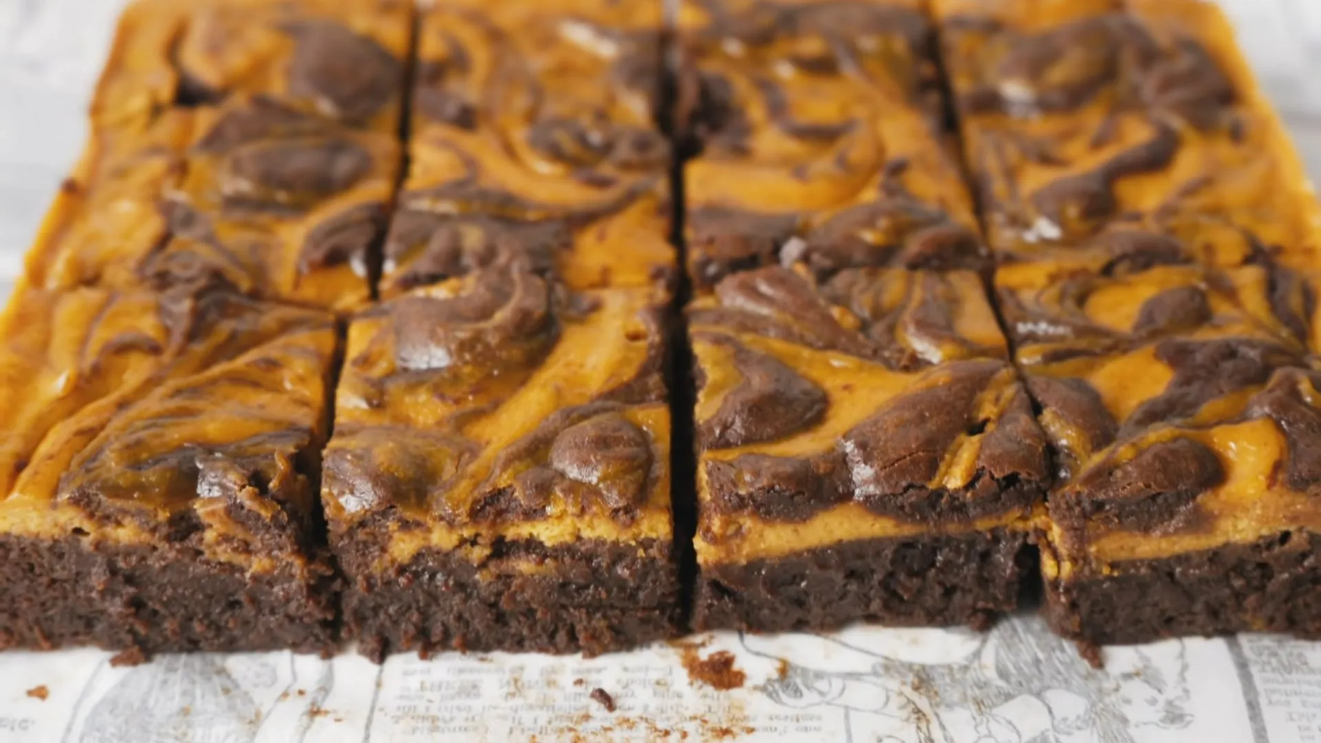 Pumpkin Cheesecake Swirl Brownies Recipe | Fudgy Fall Dessert 1 Freshly baked pumpkin cheesecake swirl brownies cut into squares