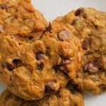Close up view of pumpkin chocolate chip oatmeal cookie with melted chocolate and oats.