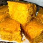 Moist sweet potato cornbread slice with melting butter.