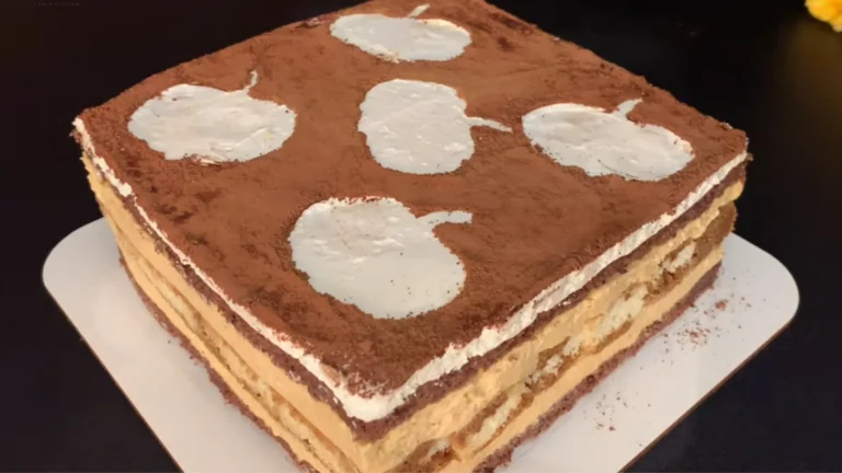 Pumpkin Spice Tiramisu Recipe (No Bake Fall Dessert) 5 Pumpkin spice tiramisu topped with cinnamon in a glass baking dish