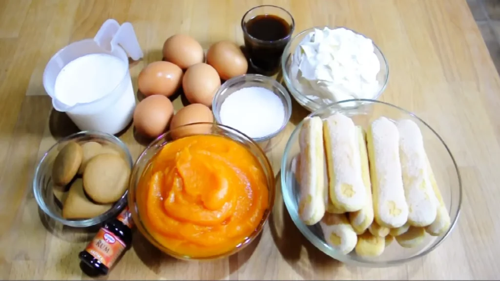 Pumpkin Spice Tiramisu Recipe (No Bake Fall Dessert) 2 Flat lay of ingredients for pumpkin tiramisu including pumpkin puree, mascarpone, and ladyfingers