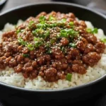 Delicious Korean ground beef bowl with rice and sesame seeds.