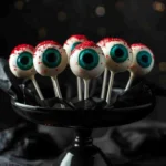 Finished Monster Eyeball Cake Pops decorated with candy eyes and red frosting veins.
