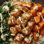 Healthy chicken and sweet potato rice bowl served with creamy dressing.