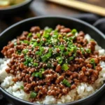 Korean ground beef bowl served with fried egg and sesame seeds.