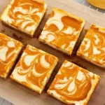 Pumpkin Spice Cheesecake Bars with graham crust and swirled top
