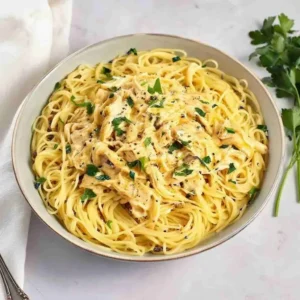 Crock Pot Angel Chicken 4 Crock pot angel chicken served over angel hair pasta on a white plate