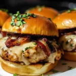 Maple chicken bacon sliders topped with melted cheese on Hawaiian rolls