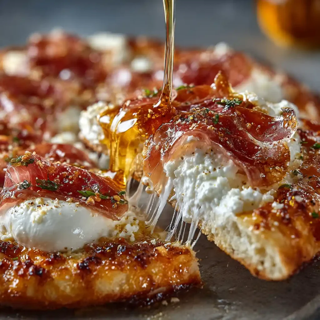 Close-up of burrata and honey on pizza