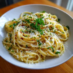 Buttery Garlic Noodles with Parmesan served on a plate with fresh herbs